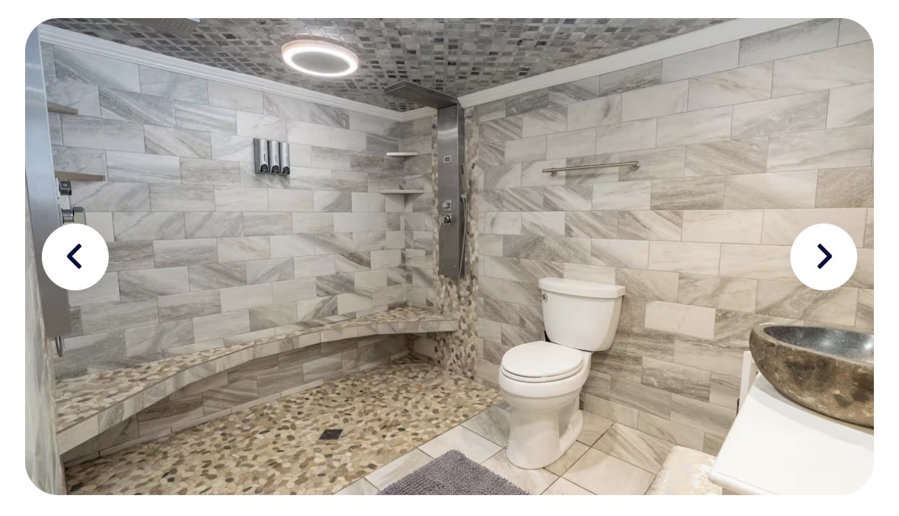 The Florida Room spa shower — stainless multi-jet panel with rainfall head, handheld, and body jets