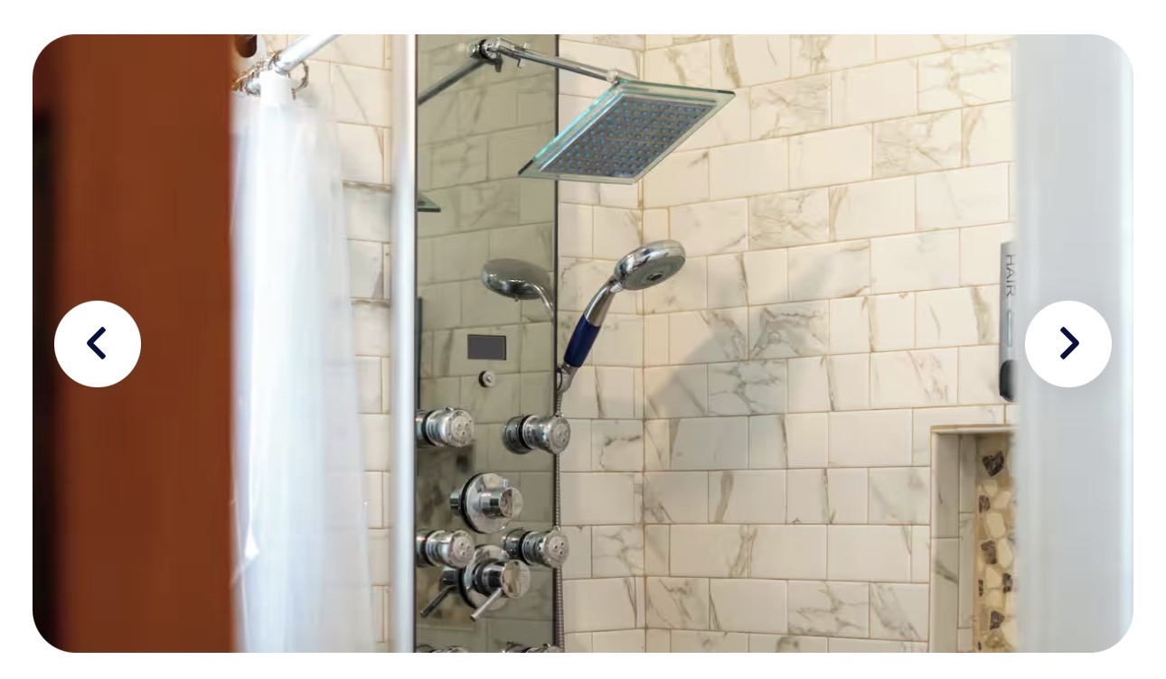 The Heron House spa shower — stainless multi-jet panel with rainfall head, handheld, and body jets